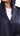 Close-up of 3D logo button on dark navy blazer abaya